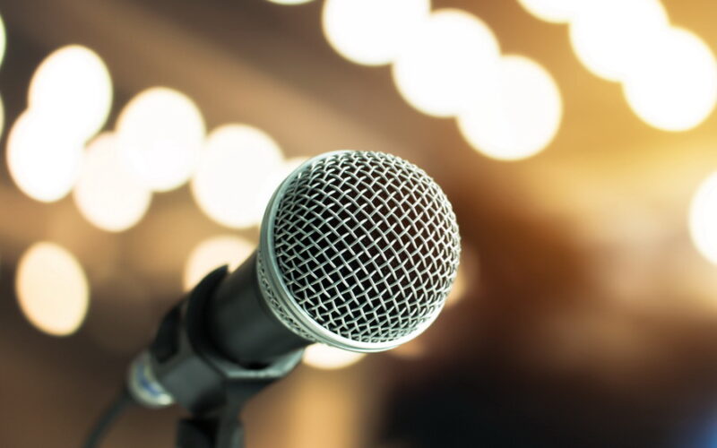 close up of microphone with blurred stage lights in the background