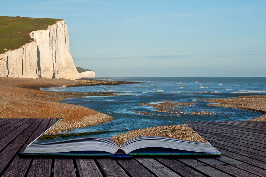 Creative composite image of seascape in pages of magic book